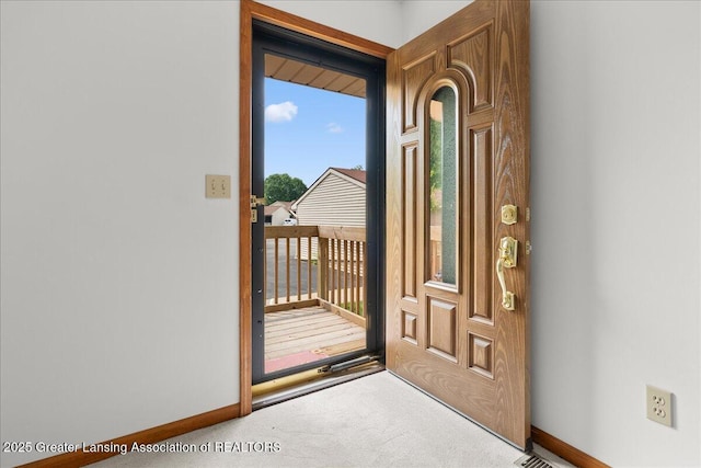 235 Bonnie Brook Dr Unit 1, Charlotte, MI 48813 - entrance foyer with carpet floors and baseboards