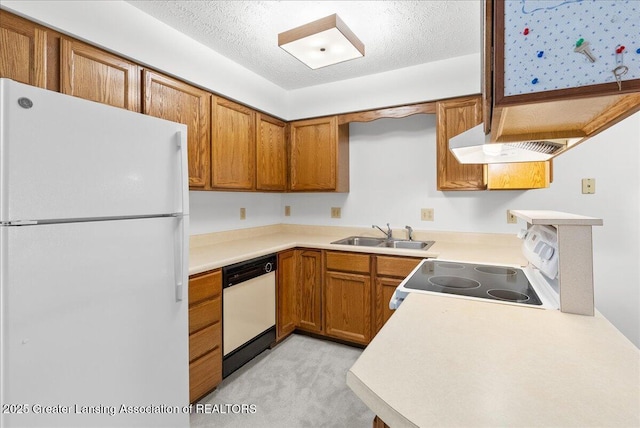 235 Bonnie Brook Dr Unit 1, Charlotte, MI 48813 - kitchen with white appliances, under cabinet range hood, brown cabinets, light carpet, and light countertops