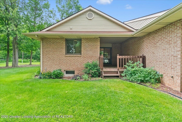 235 Bonnie Brook Dr Unit 1, Charlotte, MI 48813 - view of front of home with a deck, brick siding, and a front yard