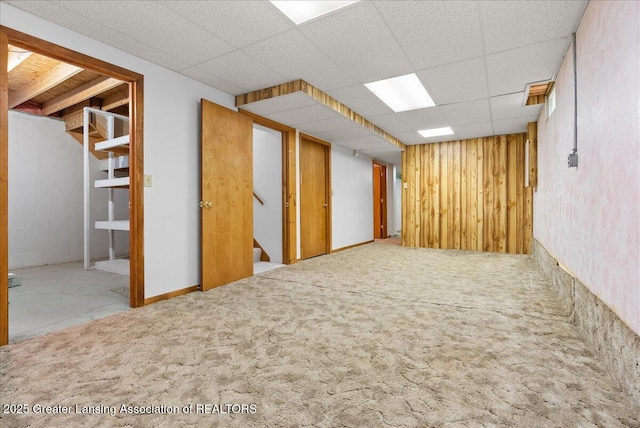 235 Bonnie Brook Dr Unit 1, Charlotte, MI 48813 - finished basement with stairs, a drop ceiling, and carpet flooring
