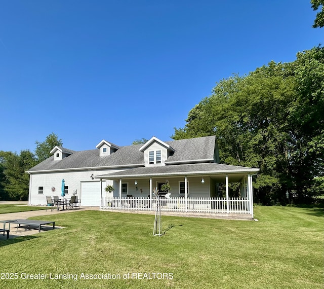 10497 Charlotte Hwy, Portland, MI 48875 - view of front of home with a front yard, a garage, roof with shingles, and covered porch