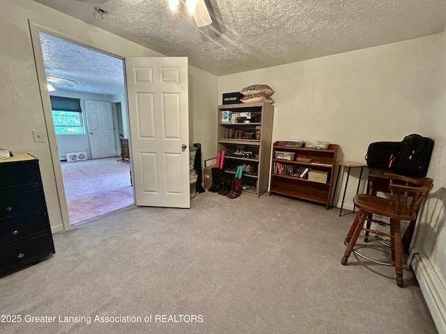 10497 Charlotte Hwy, Portland, MI 48875 - living area with a baseboard radiator, carpet, a textured ceiling, and a ceiling fan