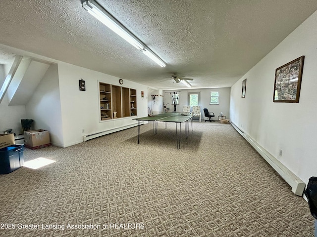 10497 Charlotte Hwy, Portland, MI 48875 - recreation room featuring a baseboard radiator, carpet flooring, a textured ceiling, and a ceiling fan