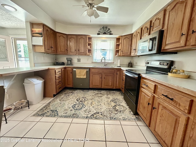 10497 Charlotte Hwy, Portland, MI 48875 - kitchen featuring stainless steel appliances, open shelves, ceiling fan, brown cabinets, and healthy amount of natural light