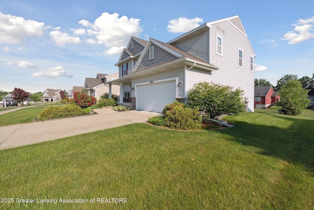 8687 Yellowstone Ln, Lansing, MI 48917 - view of home's exterior with concrete driveway, a yard, and an attached garage