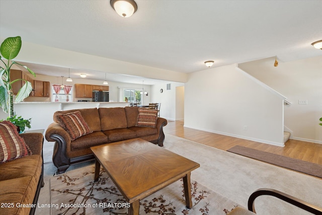 8687 Yellowstone Ln, Lansing, MI 48917 - living area featuring stairway and light wood-style floors