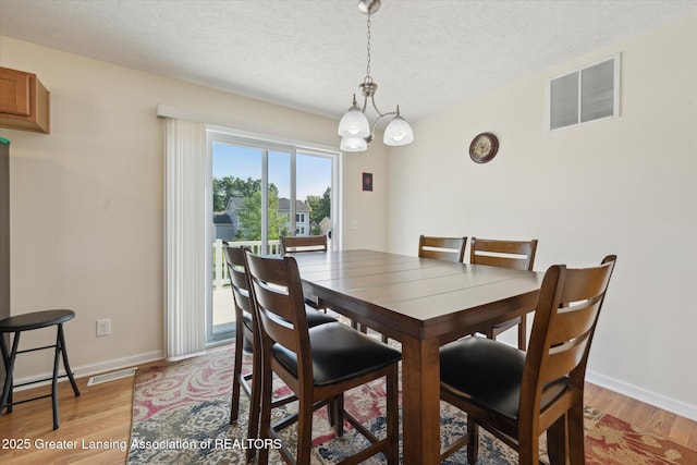 8687 Yellowstone Ln, Lansing, MI 48917 - dining space with light wood finished floors and a textured ceiling