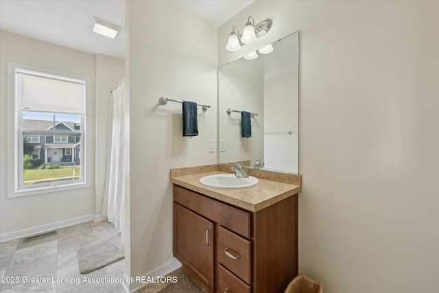 8687 Yellowstone Ln, Lansing, MI 48917 - full bathroom featuring vanity and baseboards