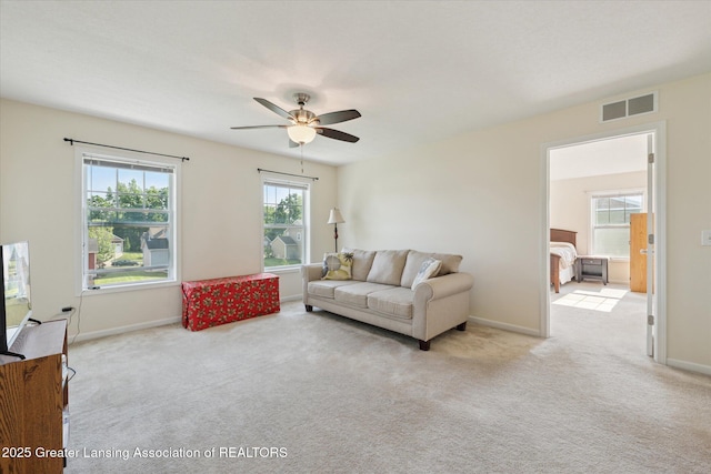 8687 Yellowstone Ln, Lansing, MI 48917 - living room featuring a ceiling fan and light colored carpet