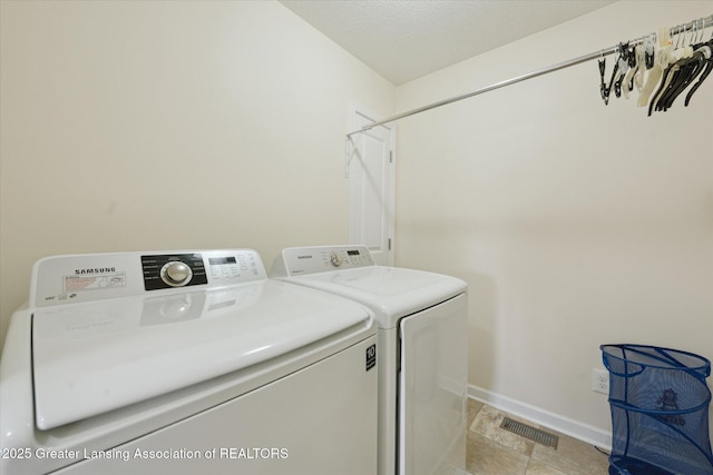 8687 Yellowstone Ln, Lansing, MI 48917 - washroom with independent washer and dryer and light stone finish floors