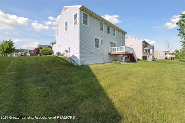 8687 Yellowstone Ln, Lansing, MI 48917 - back of house with stairway, a deck, and a lawn