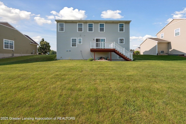 8687 Yellowstone Ln, Lansing, MI 48917 - back of house featuring stairway, a lawn, and a deck