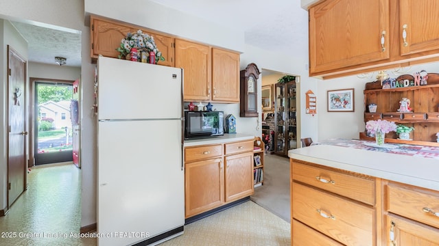 533 Middlebury Ln, Mason, MI 48854 - kitchen with freestanding refrigerator, black microwave, light countertops, and a textured ceiling