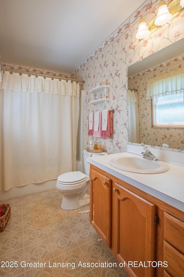 533 Middlebury Ln, Mason, MI 48854 - full bathroom with wallpapered walls, vanity, and shower / bath combo with shower curtain