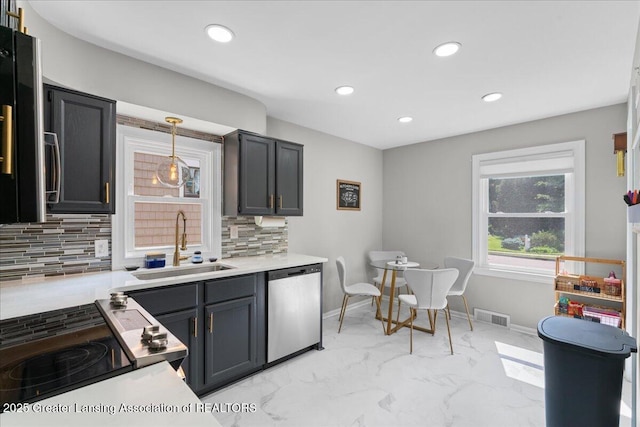 952 Sunset Ln, East Lansing, MI 48823 - kitchen with stainless steel dishwasher, electric range, backsplash, recessed lighting, and light countertops