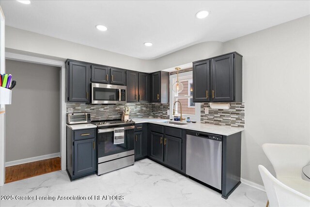 952 Sunset Ln, East Lansing, MI 48823 - kitchen with appliances with stainless steel finishes, light marble finish flooring, light countertops, and recessed lighting