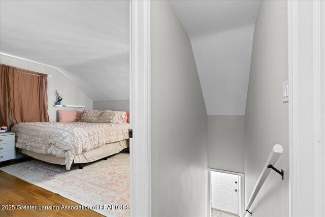 952 Sunset Ln, East Lansing, MI 48823 - bedroom with vaulted ceiling and wood finished floors