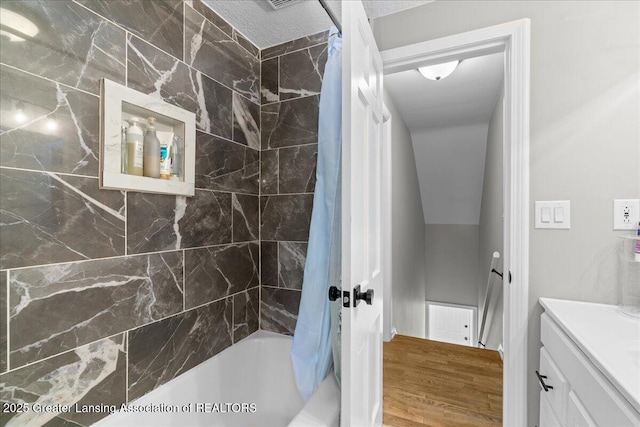 952 Sunset Ln, East Lansing, MI 48823 - bathroom with shower / bath combo, vanity, and wood finished floors