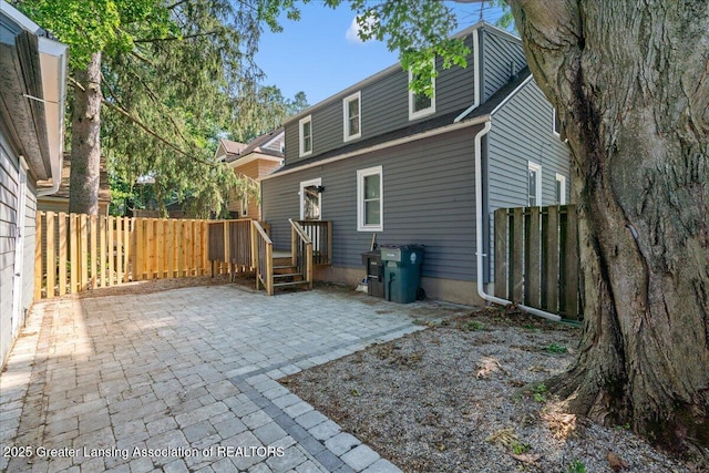 952 Sunset Ln, East Lansing, MI 48823 - rear view of house featuring a fenced backyard and a patio area