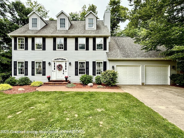 1204 Burlington Dr, Grand Ledge, MI 48837 - colonial home with driveway, an attached garage, a front lawn, a chimney, and a shingled roof