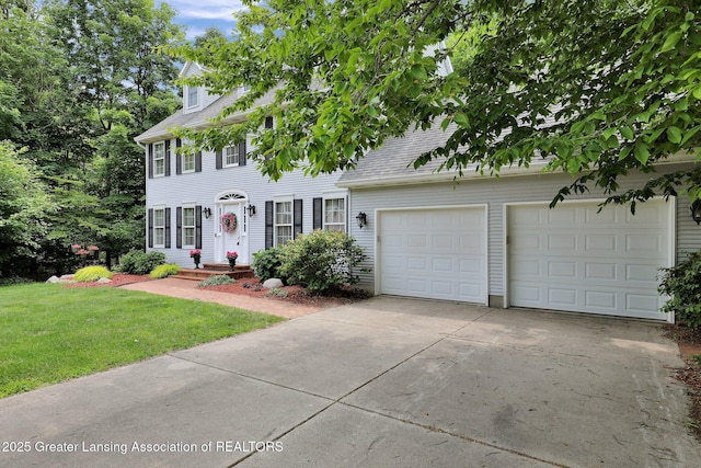 1204 Burlington Dr, Grand Ledge, MI 48837 - colonial home with concrete driveway, a front lawn, a garage, and a shingled roof