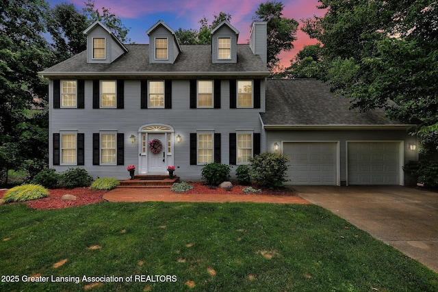 1204 Burlington Dr, Grand Ledge, MI 48837 - colonial inspired home featuring a garage, driveway, a front lawn, and a chimney