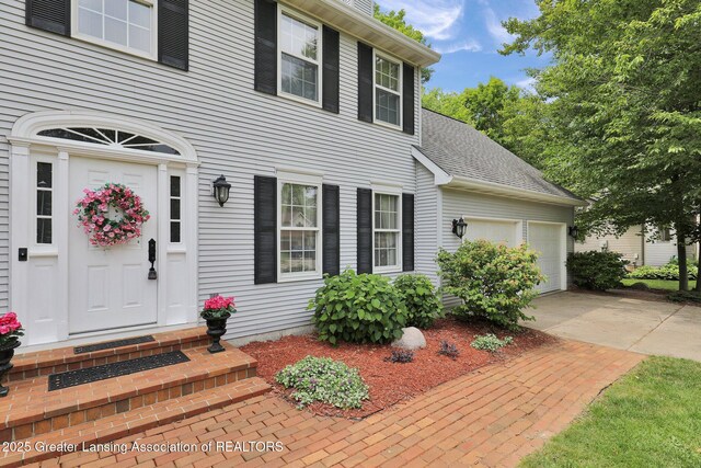 1204 Burlington Dr, Grand Ledge, MI 48837 - view of front facade with driveway and a garage