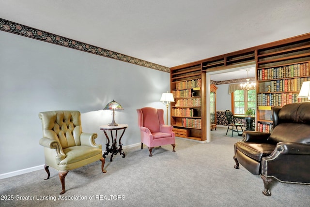 1204 Burlington Dr, Grand Ledge, MI 48837 - sitting room featuring a chandelier, carpet flooring, and built in shelves