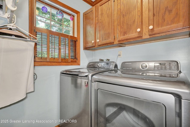 1204 Burlington Dr, Grand Ledge, MI 48837 - laundry room featuring cabinet space and separate washer and dryer