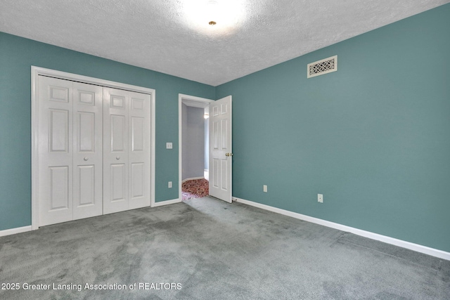 1204 Burlington Dr, Grand Ledge, MI 48837 - unfurnished bedroom featuring a textured ceiling, carpet, and a closet