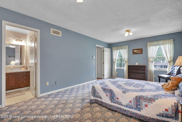 1204 Burlington Dr, Grand Ledge, MI 48837 - bedroom featuring a textured ceiling, carpet floors, and ensuite bath