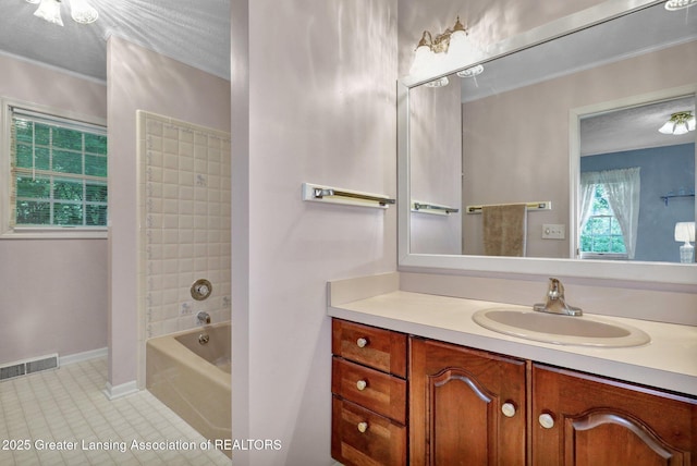 1204 Burlington Dr, Grand Ledge, MI 48837 - full bath featuring tile patterned floors, vanity, and shower / bathtub combination