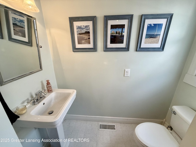 3321 Springbrook Ln, Lansing, MI 48917 - bathroom featuring toilet and baseboards