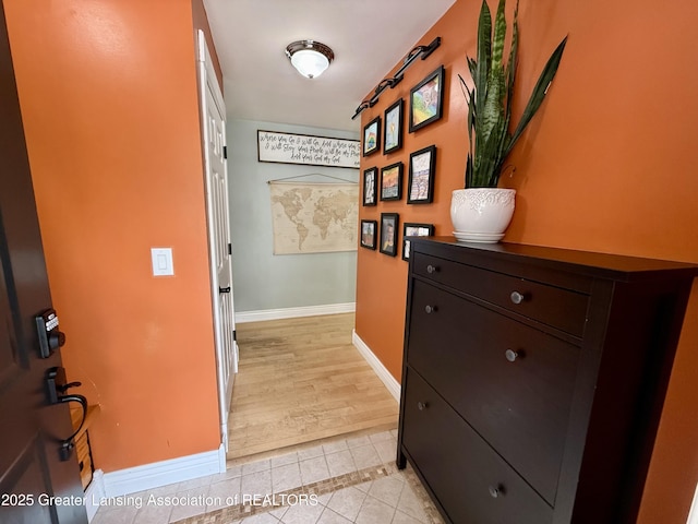 3321 Springbrook Ln, Lansing, MI 48917 - hallway with light tile patterned floors and baseboards