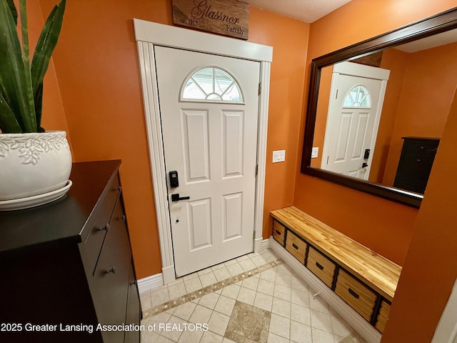 3321 Springbrook Ln, Lansing, MI 48917 - foyer with light tile patterned floors and inlaid floor details