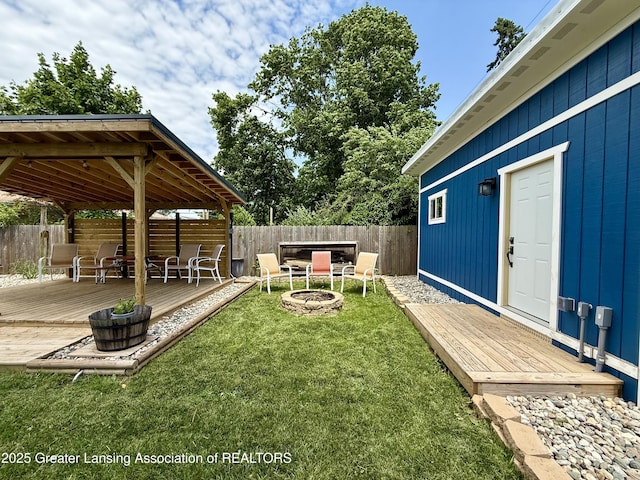 3321 Springbrook Ln, Lansing, MI 48917 - fenced yard featuring an outdoor fire pit, a wooden deck, and a gazebo