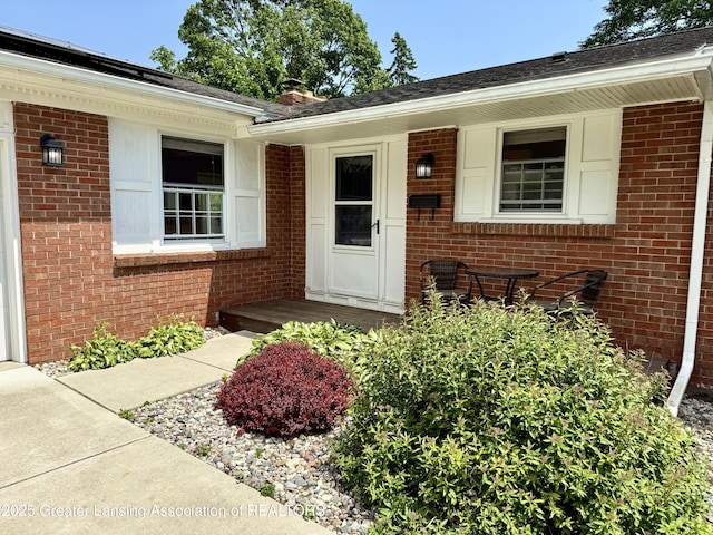 3321 Springbrook Ln, Lansing, MI 48917 - doorway to property with brick siding and a chimney