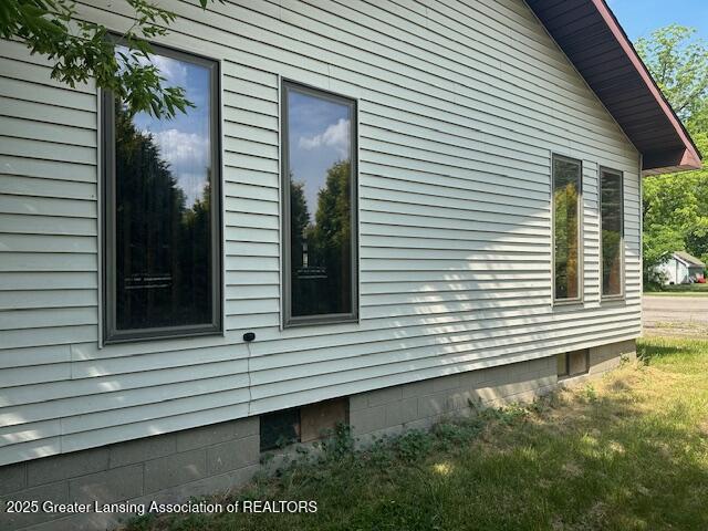 5681 Shaw St, Haslett, MI 48840 - view of side of home featuring a yard