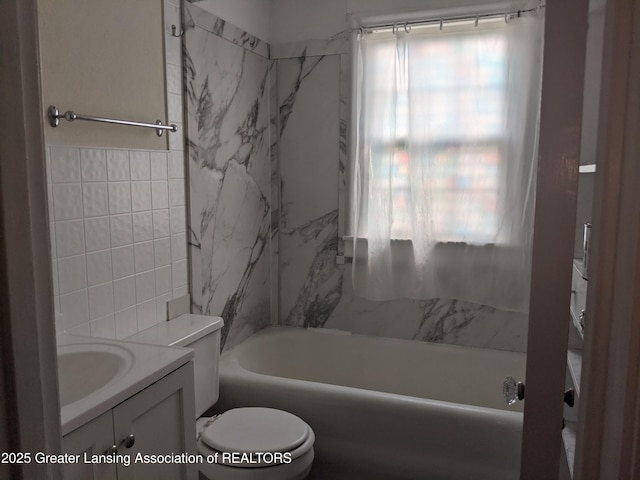 542 Riley St, Lansing, MI 48910 - bathroom featuring tile walls, vanity, and tub / shower combination
