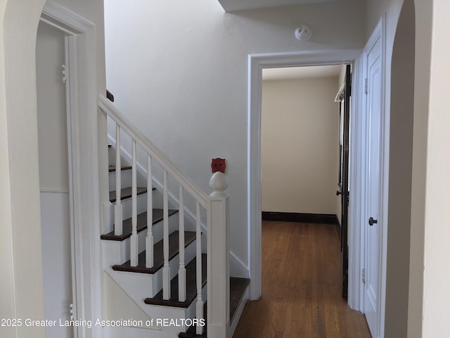 542 Riley St, Lansing, MI 48910 - staircase featuring wood finished floors and arched walkways