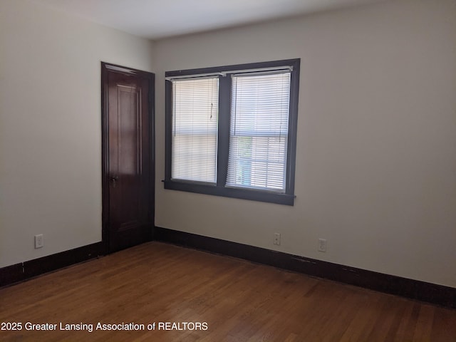 542 Riley St, Lansing, MI 48910 - spare room featuring dark wood-style flooring and baseboards