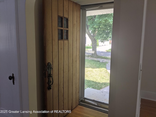 542 Riley St, Lansing, MI 48910 - entryway featuring wood walls, arched walkways, and wood finished floors