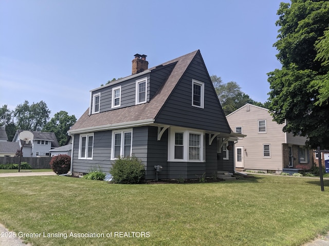 542 Riley St, Lansing, MI 48910 - view of front facade with a chimney and a shingled roof