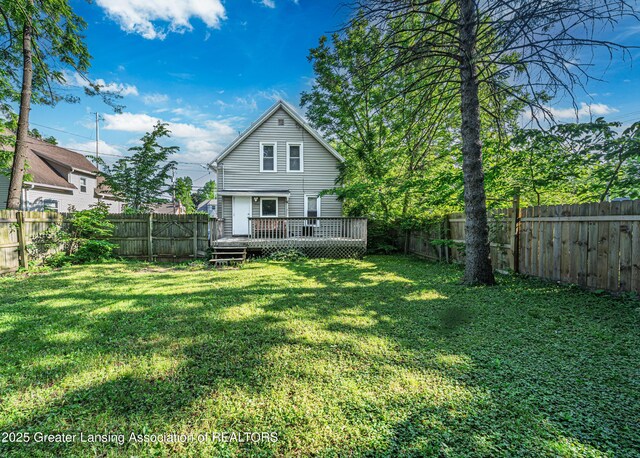 1407 W Ionia St, Lansing, MI 48915 - back of house with a fenced backyard and a wooden deck