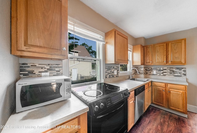 1407 W Ionia St, Lansing, MI 48915 - kitchen featuring white microwave, black range with electric stovetop, dishwasher, and light countertops