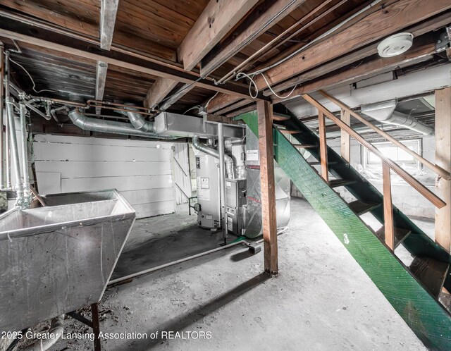 1407 W Ionia St, Lansing, MI 48915 - unfinished basement featuring gas water heater, stairs, and heating unit