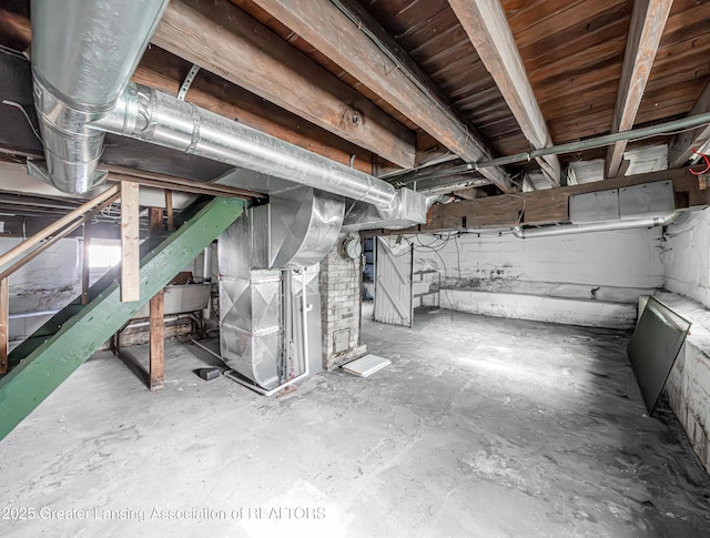 1407 W Ionia St, Lansing, MI 48915 - unfinished basement with heating unit and stairway