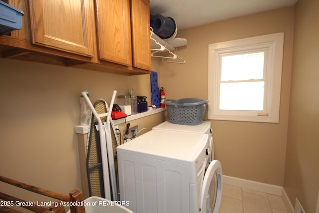 8522 Ember Glen Pass, Lansing, MI 48917 - laundry area with washing machine and dryer, cabinet space, and light tile patterned flooring