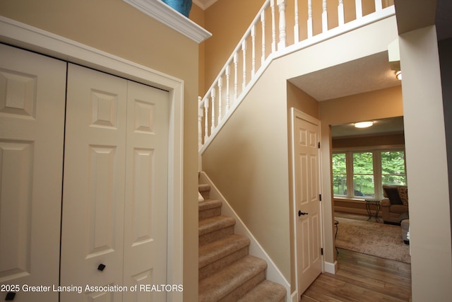 8522 Ember Glen Pass, Lansing, MI 48917 - staircase featuring wood finished floors and baseboards