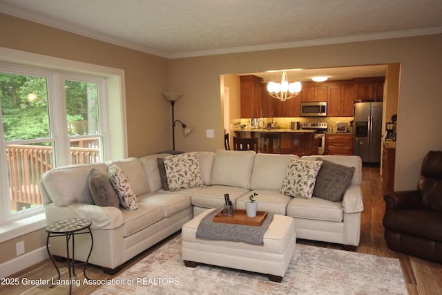 8522 Ember Glen Pass, Lansing, MI 48917 - living area with a chandelier, wood finished floors, and crown molding